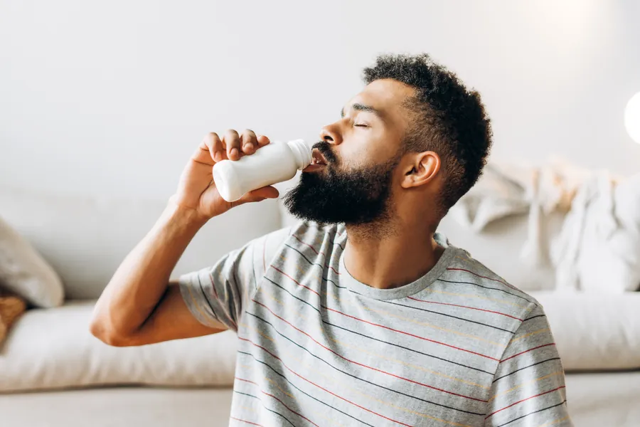 Man drinking probiotic yogurt
